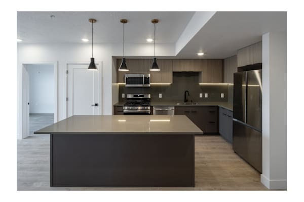 A modern kitchen with a large island in the center.